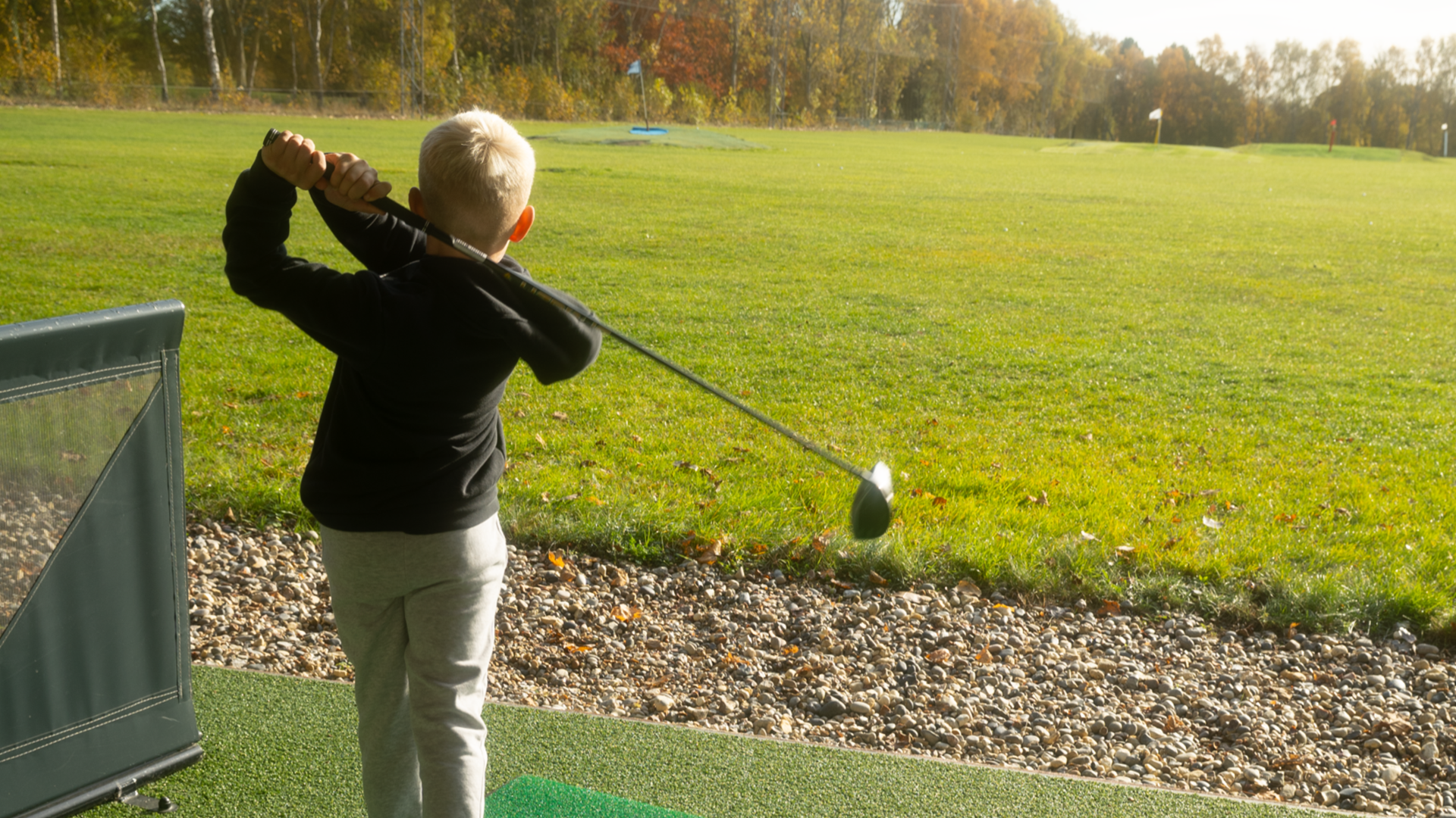 a close up of a junior golfer in his golf swing