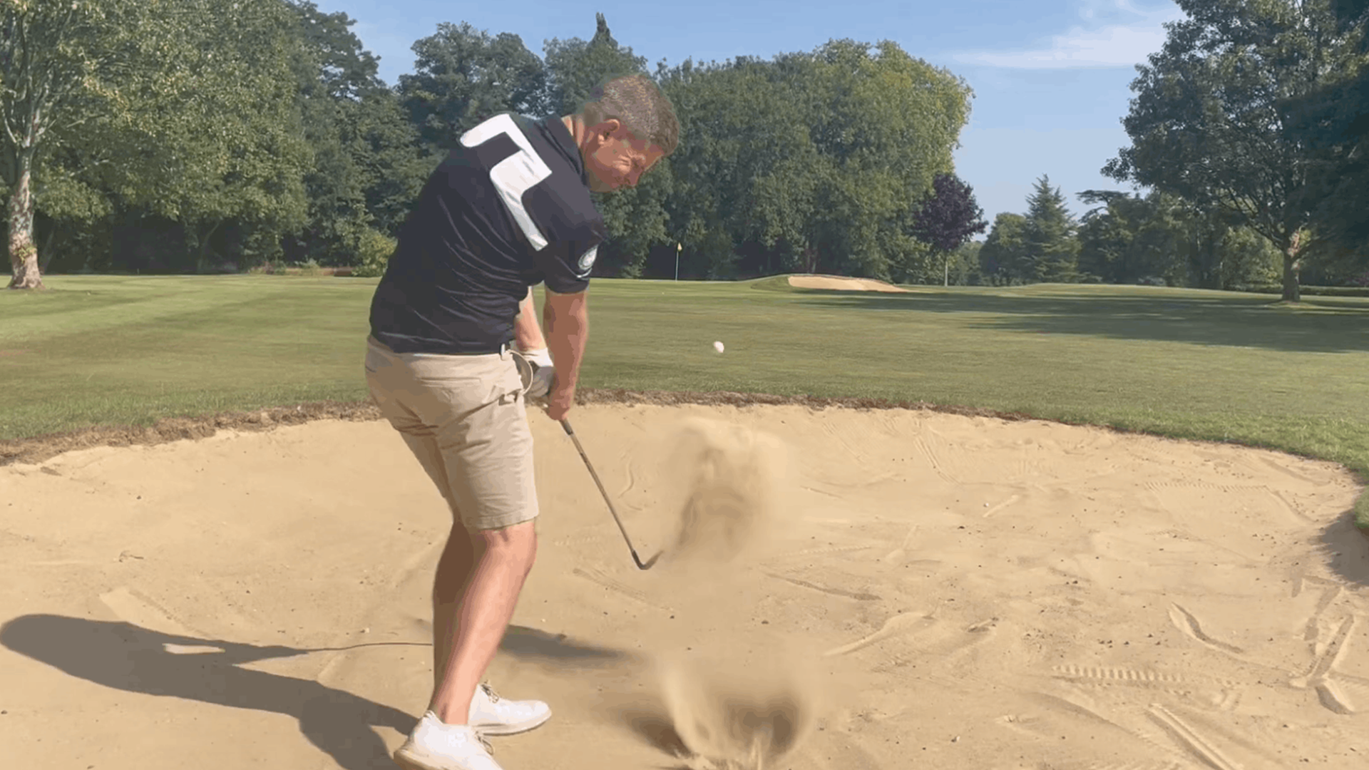 a close up of ian taylor showing his fairway bunker shots through tuition