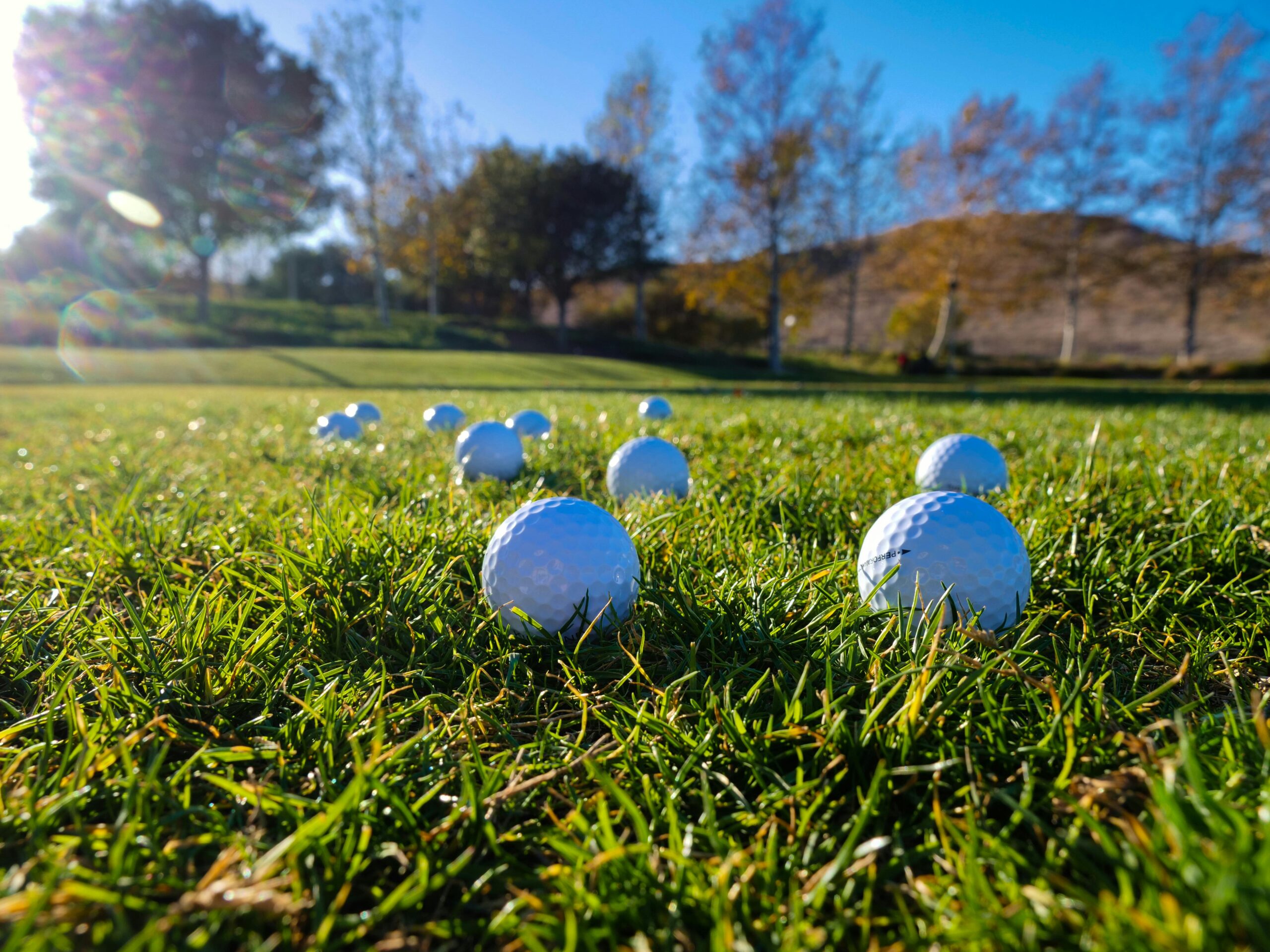 pexels-kindelmedia-6572964 Golf balls laying in the grass